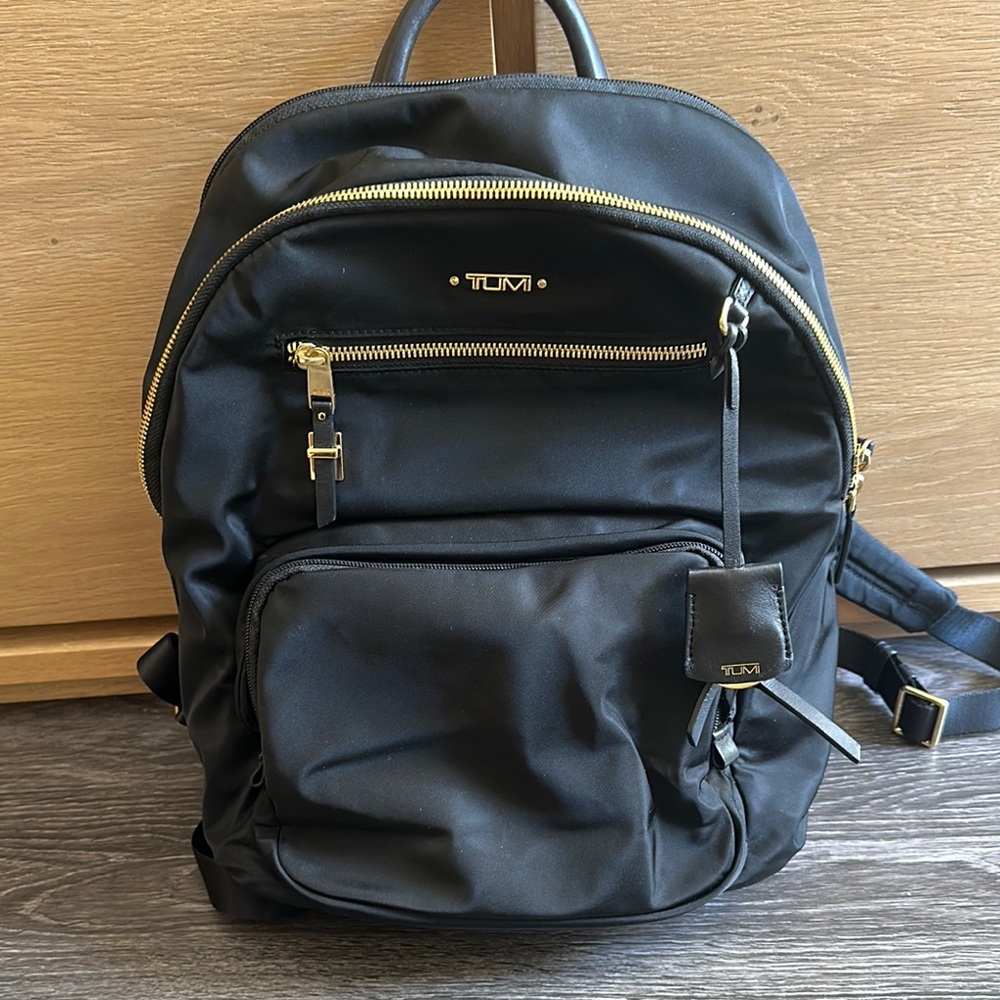 TUMI Black Backpack with Gold Accents